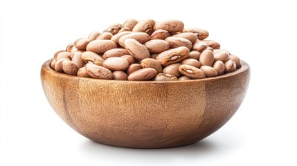 Wooden bowl filled with pinto beans against a white backdrop