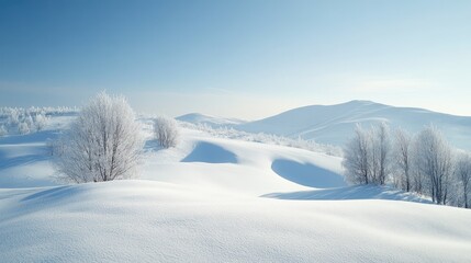 Obraz premium Winter landscape featuring snow covered hills beneath a clear blue sky