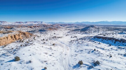 Aerial Perspective of a Snow Covered Desert Landscape Under Clear Blue Skies