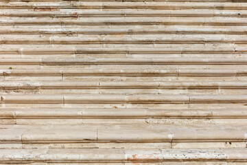 The image is of a wall with a lot of cracks and dirt