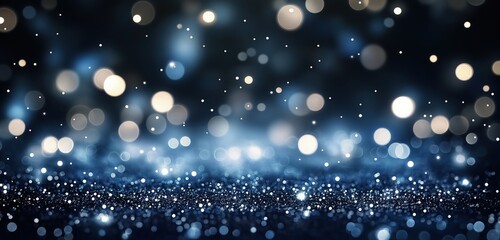 An abstract background featuring de-focused glittering blue and silver lights, softly glowing against a deep navy backdrop. 