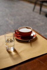 Fresh brewed coffee and glass with still water on the table