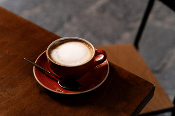 Ceramic cup with cappuccino on the table. Coffee background