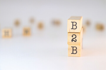 B2B sign on wooden cubes isolated on white background with copy space