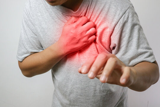 a man touching his heart, with red highlight of heart attack, and others heart disease concept, on white background