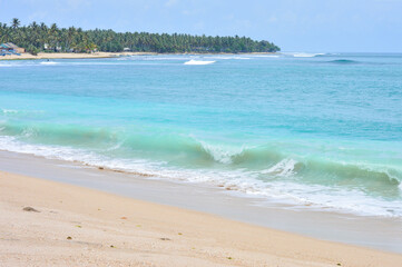 The panorama of beautiful beach with blue water and clear sand in Indonesia