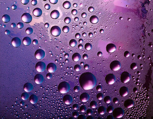 Colorful Spectrum Water Droplets on Glass Displaying a Range of Purple Hues
