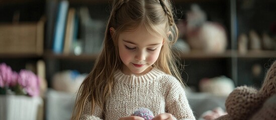 Little Girl Is Engaged In Needlework At Home
