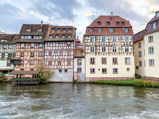 historic half timbered house with reflection in the canals of Strasbourg, France