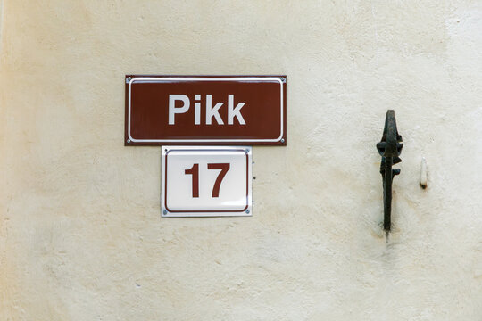 old enamel streetname pikk in Tallinn, Estonia at an old wall in the old town