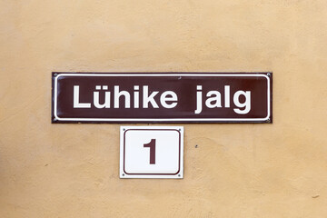 old enamel streetname L&uuml;hike jalg,1   in Tallinn, Estonia at an old wall in the old town