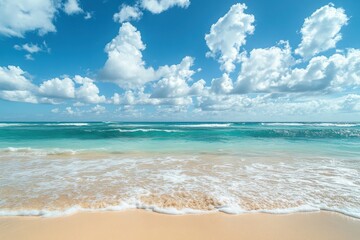 Obraz premium Coastal beach with a blurred blue ocean under a radiant sky sprinkled with gentle fluffy clouds