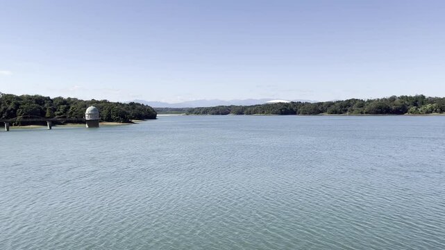View of Tama Lake seen from Sayama Park, Tokyo on a Sunny Day. It was take on early Autumn. Structure seen at the left is a Water Utility Facility.