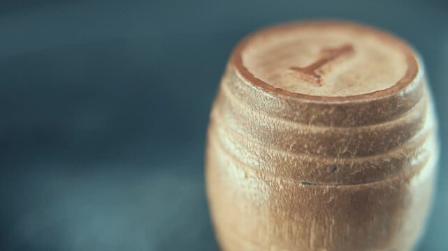 Macro steady shot of Bingo wooden barrel on a rotating stand, rotating 360, lucky number 55, board game, 4K video