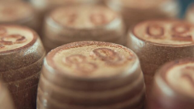 Macro steady shot of Bingo wooden barrels on a rotating stand, rotating 360, lucky numbers, board game, 4K