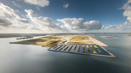 Amsterdam’s Strandeiland, an artificial island under development in IJburg. This future sustainable housing district features new land, designed for eco-friendly urban living. Aerial panorama. 