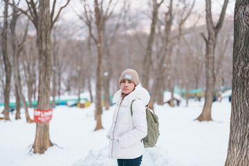Woman tourist with snow in winter season at Zao fox village, traveler sightseeing Miyagi...