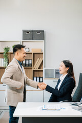 Two confident business man shaking hands during a meeting in the office