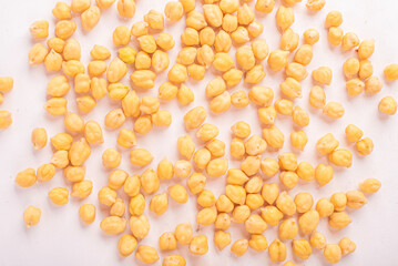 Chickpeas, raw and uncooked. Chickpea or garbanzo bean background. Full body photo of dry yellow colored shelled garbanzo beans. Close up view of chickpeas for cooking or health food concept