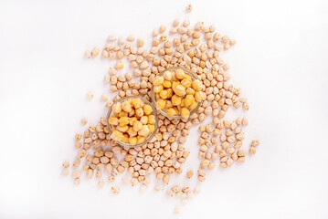 A bowl of chickpeas is on a white table