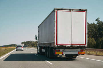 Commercial truck driving on country highway.