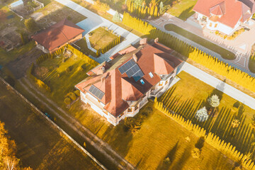 Modern house with rooftop solar panels in countryside