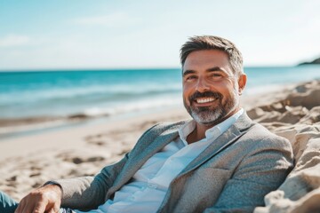 A person relaxing on a beach with the ocean in the background, suitable for travel or leisure related projects