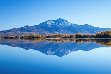 A mountain range is reflected in the water