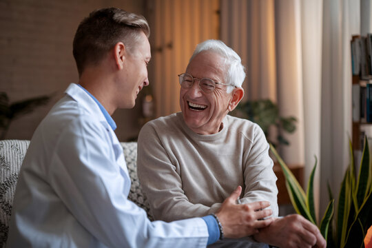 Joyful Moment Between Doctor and Patient. A heartwarming scene captures a doctor and patient sharing laughter in a cozy setting.