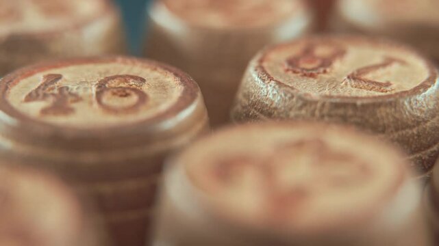 Macro steady shot of Bingo wooden barrels on a rotating stand, rotating 360, lucky numbers, board game, 4K smooth video