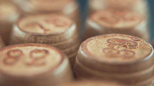 Macro steady shot of Bingo wooden barrels on a rotating stand, rotating 360, lucky numbers, board game, 4K
