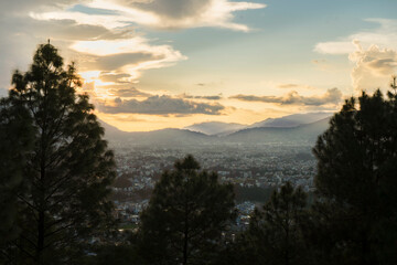 Beautiful Sunset Golden Hour of Kathmandu Valley City in Nepal with Mountains and trees