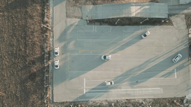 Multiple automobiles practicing exercises on a driving lot for beginners. Car driving school.