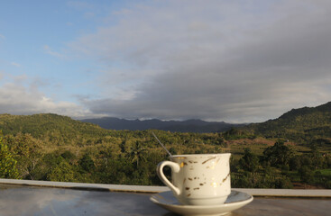 empty coffee cup on mountain nature landscape background. Good luck in drinking coffee