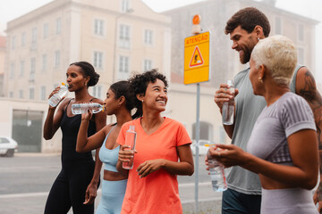 Group of athletes hydrating after training in the city