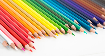 Colored pencils lying in irregular row
