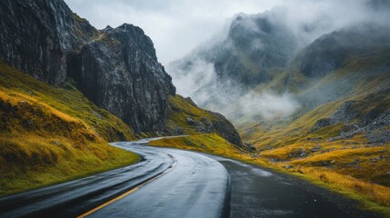 Naklejka premium Winding Road Through Misty Mountain Pass