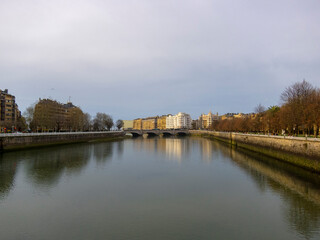 Panoramic view of the tourist city of San Sebastian in the Basque country, at sunset with the river Urumea flowing through the city on a sunny day.