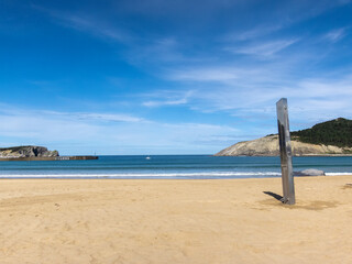 Panoramic view of the beach of Plencia with its white sand and crystal clear sea on a sunny summer day in the Basque country.