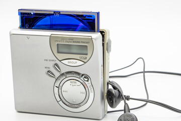 Close-up of a minidisc player and recorder with headphones and a minidisc disc isolated on white...