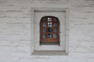 Vintage window on the external facade of a large wall of a building