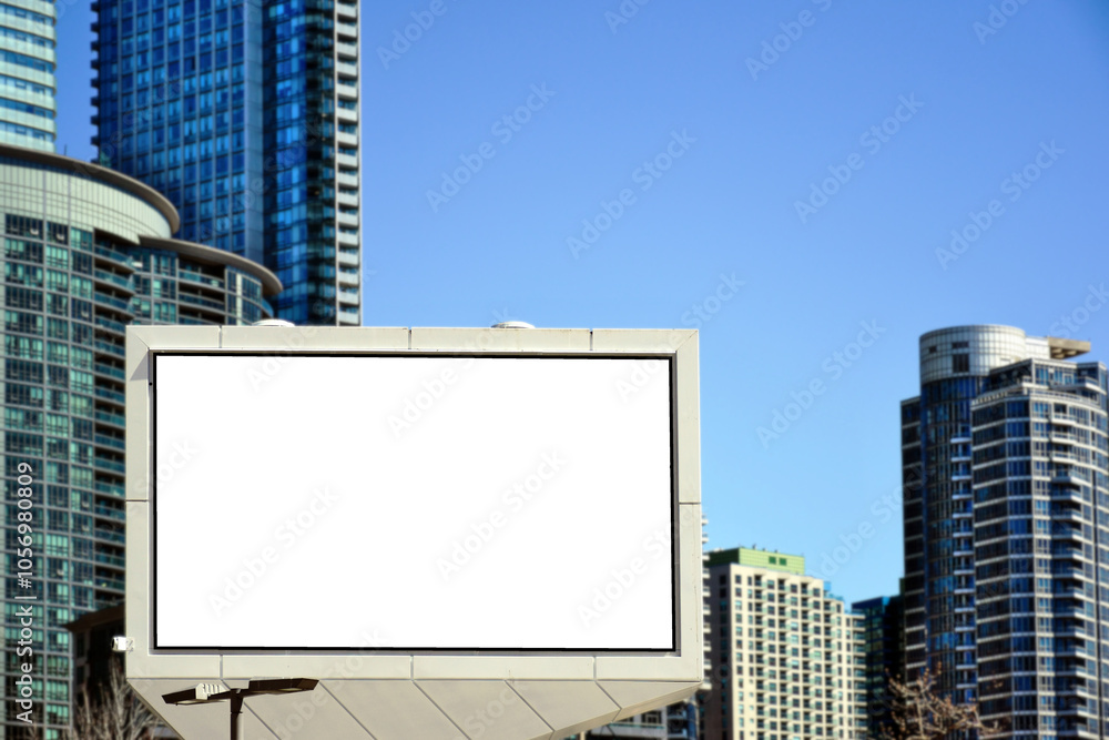 Wall mural white blank advertising billboard. street mockup panel. digital lightbox poster ad banner background. horizontal format sign. North American city background with tall residential towers. 