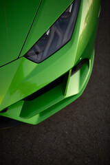 Headlight of modern luxury supercar. Close up detail vertical shot