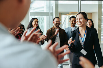 Female leader receives applause in a successful business meeting, showcasing effective leadership...