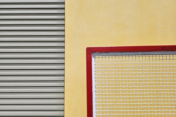 Close up Movable Metal Fence with Foldable Door and Yellow Concrete Wall Background.
