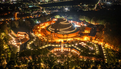 Aerial view of illuminated Kosciuszko Mound at night in Krakow, Poland