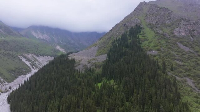 Ala Archa National Park at summer day in Kyrgyzstan, aerial view with truck camera movement.