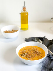 Indulge in a Deliciously Creamy Soup Topped with Savory Ingredients and a Drizzle of Olive Oil