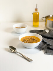 Enjoy a delicious pumpkin cream soup enriched with rich olive oil and aromatic herbs for flavor