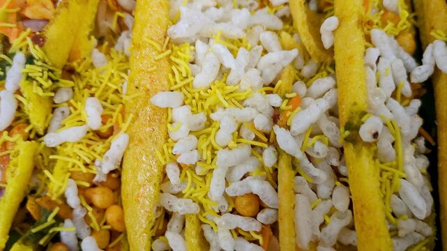 A famous boti masala chaat or crunchy finger fryums filled with puffed rice and sev
